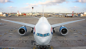 A large airplane sitting on top of an airport runway.