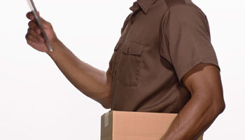 A man in brown shirt holding up his arm.