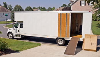 A moving truck parked in front of a house.